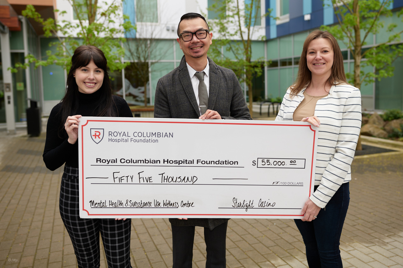 Three representatives from Starlight Casino stand proudly with large cheque representing their donation to Royal Columbian Hospital Foundation.